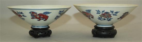 A pair of Chinese underglaze blue and copper red conical bowls, Jiajing marks, late 19th / early 20th century, 15.5cm, wood stand